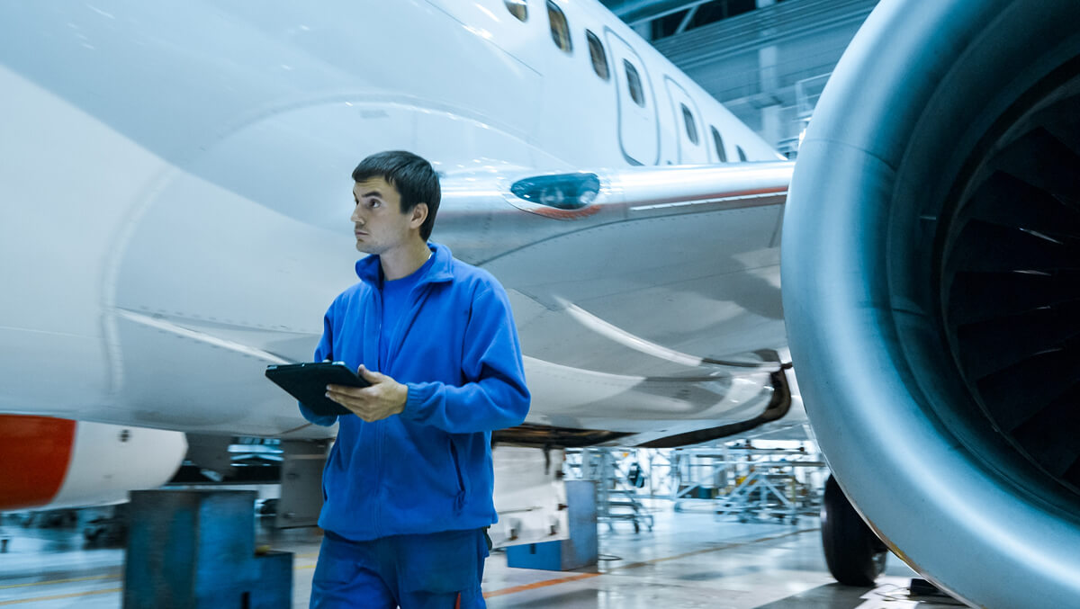 aircraft-maintenance-mechanic-uses-tablet-inspect-plane-body-hangar-image