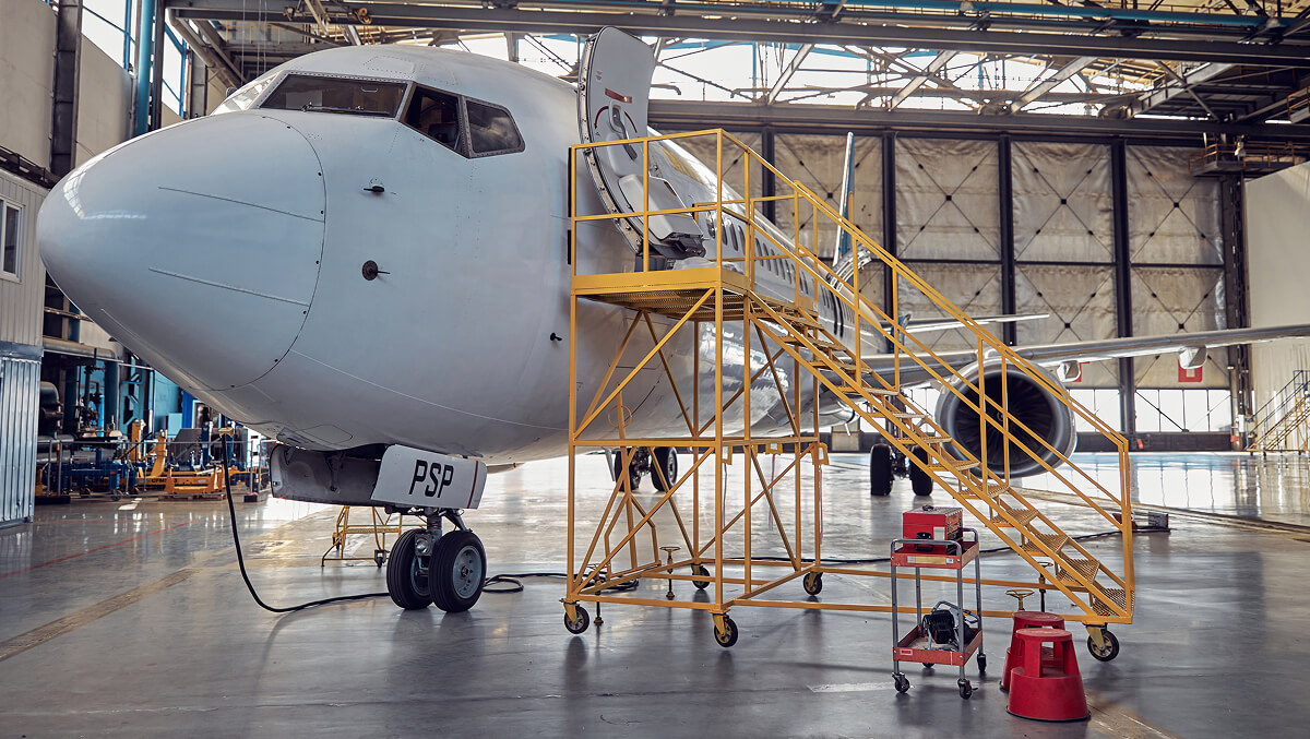 side-view-image-big-white-passenger-aircraft-standing-parking-apron-aviation-hangar-image